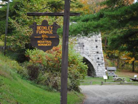 The industrial monument stone furnace with Beckley Furnace Industrial Monument sign in foreground
